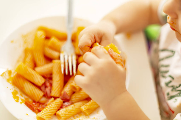 Italian Amatriciana Pasta with tomato sauce and smoked bacon served as first dish for children. Italian cuisine concept. Selective focus. - Φωτογραφία, εικόνα