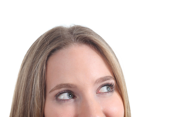 Close up of blue eyes of a woman looking above - Foto, Imagen