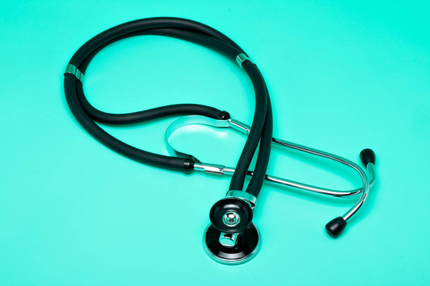 Stethoscope, medical instrument on a bright green background - Photo, Image