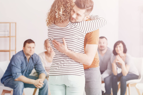Man hugging woman during group therapy for couples - Φωτογραφία, εικόνα