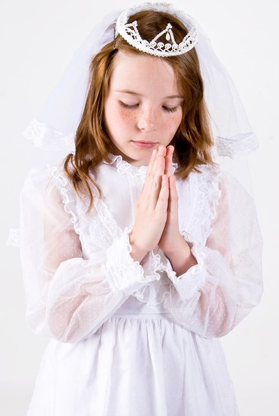 Young girl in her First Communion dress praying - Photo, Image