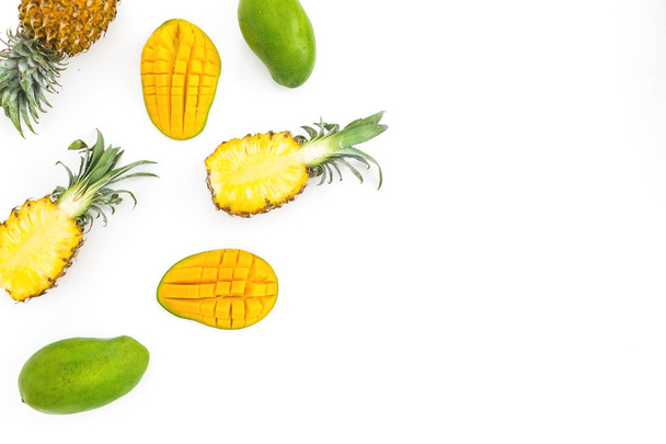 Food frame of sweet pineapple and mango fruits on white background. Flat lay, top view. Tropical concept. - Photo, image