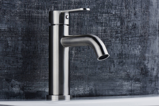 Plumbing. The interior of the bathroom. Faucet sink on black and white background. - Foto, afbeelding