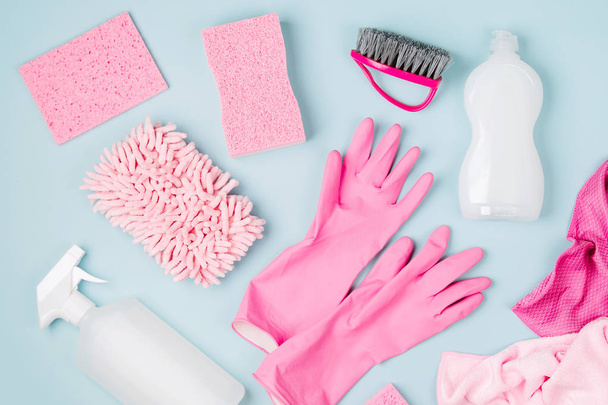 Detergents and cleaning accessories  in pink color.  Cleaning service concept. Flat lay, Top view. - Foto, Imagem