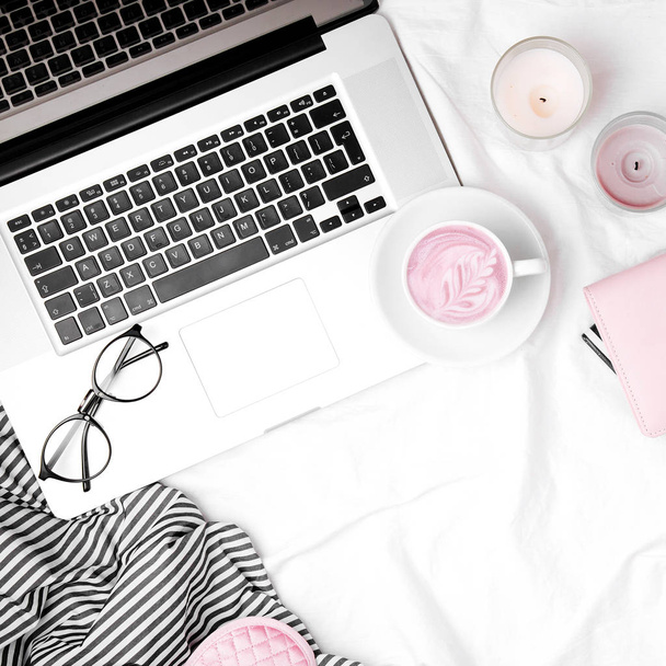 Workspace in bed with laptop and coffee. Morning concept. Flat lay  - Foto, Imagen