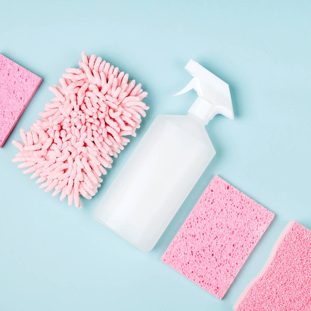 Detergents and cleaning accessories  in pink color.  Cleaning service concept. Flat lay, Top view. - Foto, Bild
