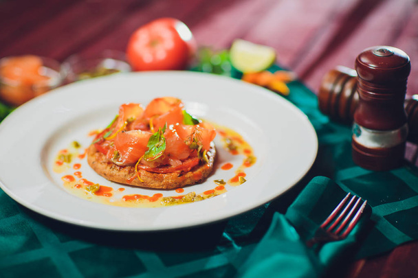 Sliced mushroom tart with cheese and tomatoes close-up on table. horizontal trout - Fotó, kép
