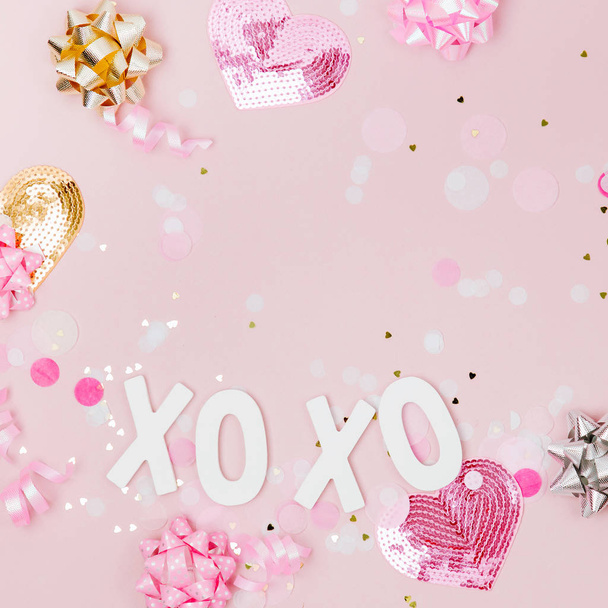 Confetti, bows and paper decorations. Valentines day or birthday party concept theme. Flat lay, top vie - Foto, Bild