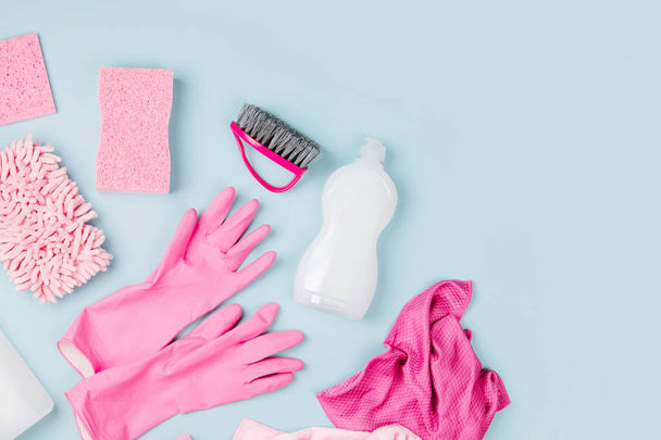 Detergents and cleaning accessories  in pink color.  Cleaning service concept. Flat lay, Top view. - Fotografie, Obrázek