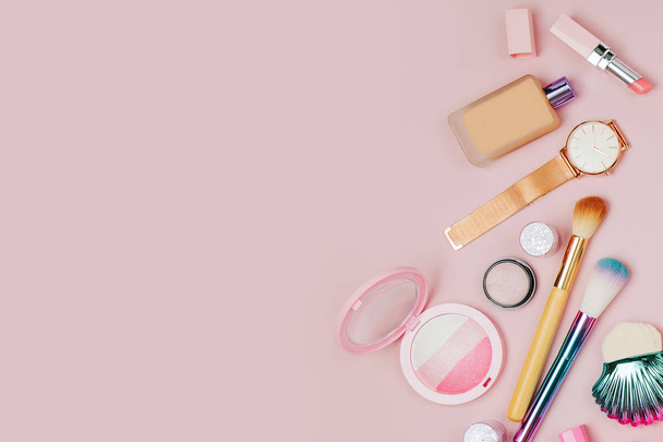 Female cosmetics collage with lipstick, brush and other accessories on pink background. Flat lay, top view. - Foto, Imagem