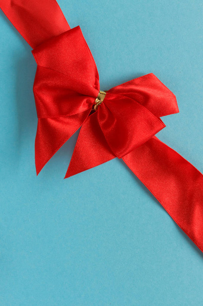 Festive bow on blue background, greeting card for Valentines Day - Fotoğraf, Görsel
