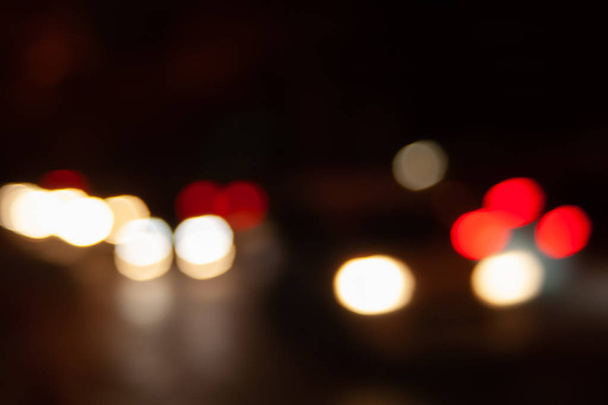 Blurred night background of city street road with bokeh effect. Abstract wallpaper for design and editing images. - Fotó, kép