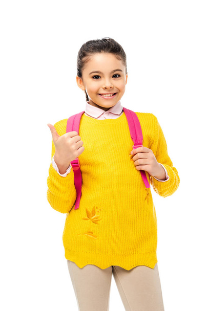 adorable child showing thumb up sign and holding pink backpack straps isolated on white  - Fotografie, Obrázek
