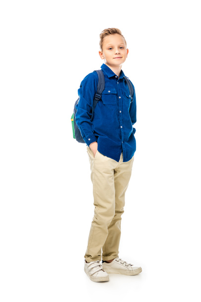 cute schoolboy in blue shirt standing with hands in pockets isolated on white - Photo, Image