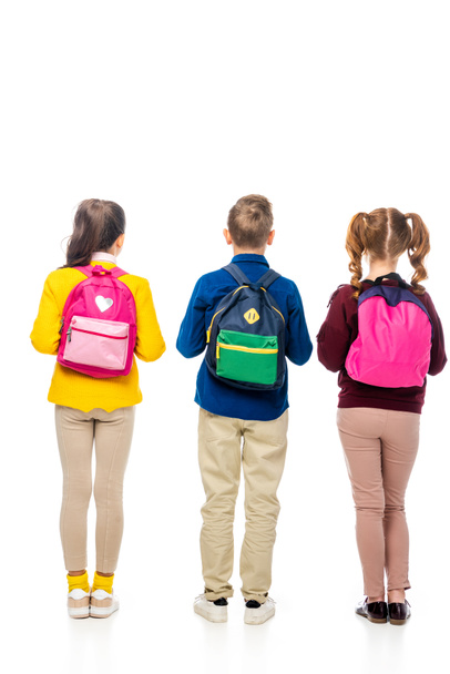 back view of schoolchildren with multicolored backpacks isolated on white - Photo, image