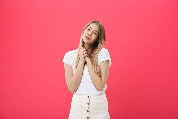 Picture of young woman praying on isolated pink background - Foto, imagen