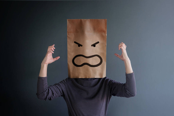 Customer Experience or Human Emotional Concept. Woman Covered her Face by Paper Bag and presenting  Angry Feeling by Drawn Line Cartoon and Body Language - Photo, Image