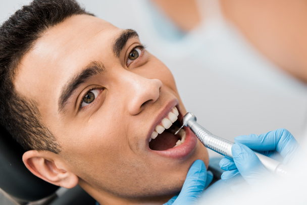női fogorvos fúrás csinos afroamerikai beteg fogak közelről - Fotó, kép