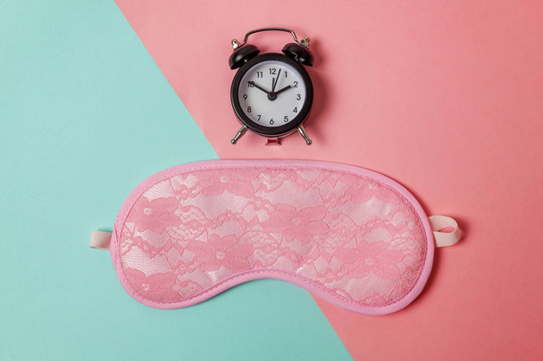 Sleeping eye mask, alarm clock isolated on blue pink pastel colorful trendy geometric background Do not disturb me, let me sleep. Rest, good night, siesta, insomnia, relaxation, tired, travel concept - Fotoğraf, Görsel