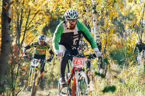 October, 14, 2018 - Minsk, Belarus: 2018 Olympic Cross Country Cup XCO in Medvezhino, men riding bicycles along forest trail - Valokuva, kuva