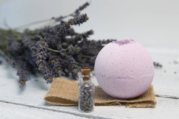 Natural cosmetics. Handmade lavender bath bombs and lavender flowers on white wooden planks - Foto, immagini