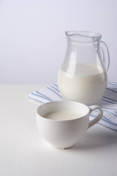 fresh milk in glass jug and glass - Fotoğraf, Görsel