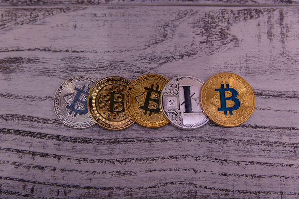 silver and gold bitcoins and Silver Litecoin on wooden background - Φωτογραφία, εικόνα