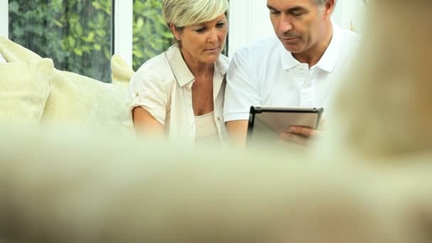 Mature Couple Using Wireless Tablet for Finances - Filmati, video