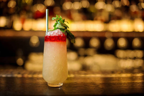 Glass of colorful sweet tropical juicy pineapple cocktail - Fotó, kép