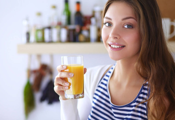 Portrait of a pretty woman holding glass with tasty juice - Fotó, kép