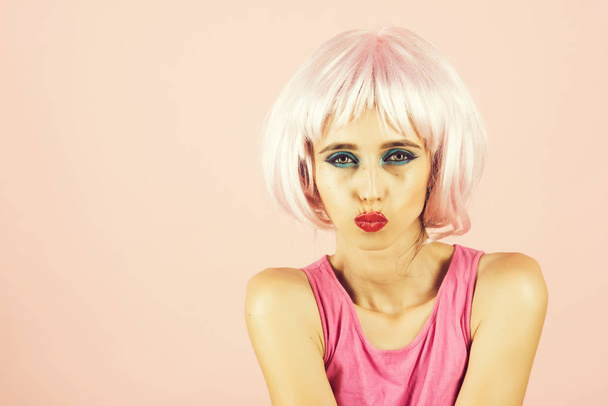 woman with pink hair wig and fashionable makeup has red lips, copy space - Fotó, kép