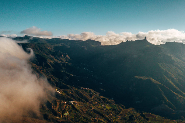 Aerial view of the Gran Canaria mountains in the middle of the island with Teide volcano view over the clouds. - Φωτογραφία, εικόνα