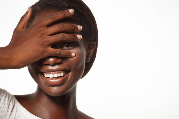 lifestyle and people concept:  young african woman laughing with her eyes closed - Foto, Bild