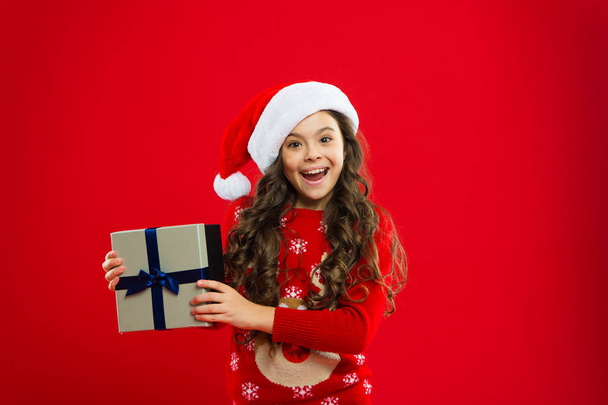 Little girl child in santa red hat. New year party. Santa claus kid. Christmas shopping. lets do something funny. Happy winter holidays. Small girl. Present for Xmas. Childhood - Photo, Image