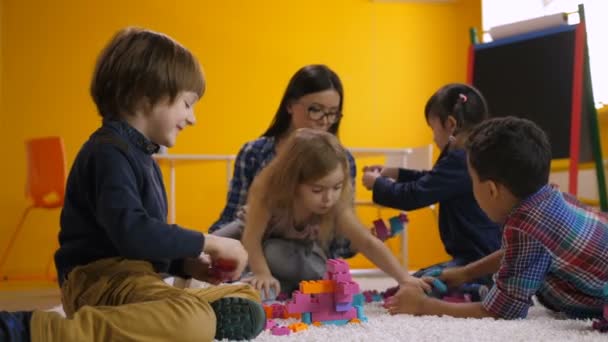 Joyful children enjoying leisure in kindergarten - Footage, Video