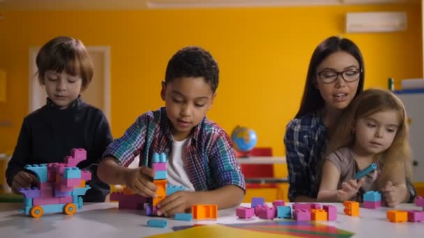 Children building with bright constructing bricks - Footage, Video