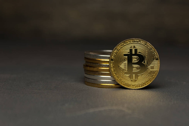  golden bitcoin stand beside pile of coins - Foto, Bild