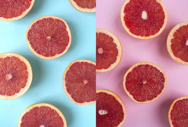 Creatieve achtergrond gemaakt van gesneden koraal kleur grapefruits op roze en blauwe achtergrond. Plat lag stijl. - Foto, afbeelding