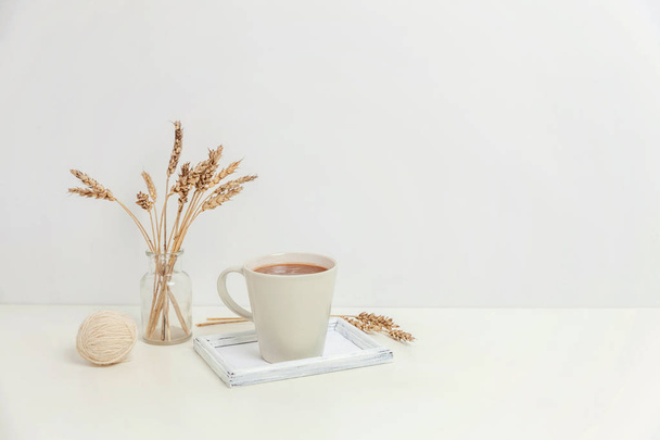 Natural eco home decor with cup coffee candle on wooden tray. Early morning breakfast lifestyle background. Interior decoration with hot drink mug. Hygge scandinavian style concept copy space - Fotoğraf, Görsel