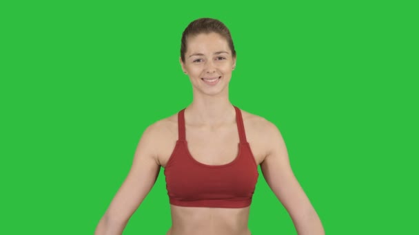 Young attractive woman practicing yoga, sitting in Gomukasana exercise, Cow Face pose, while being photographed on a Green Screen, Chroma Key. - Filmmaterial, Video