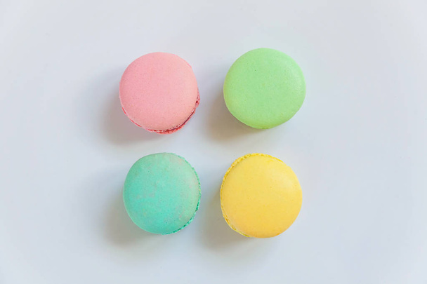 Sweet almond colorful pink, blue, yellow, green macarons on white background - Фото, изображение