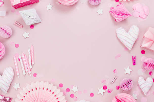 Frame made of Pink and white Paper Decorations, candy, hearts, gifts, confetti for Baby party. Flat lay, top view - Fotografie, Obrázek