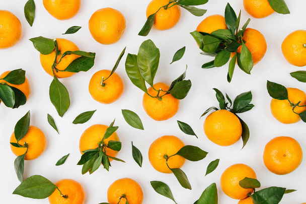 Fresh orange Mandarins, tangerine with green leaves on white background. Flat lay. Top view - Fotografie, Obrázek