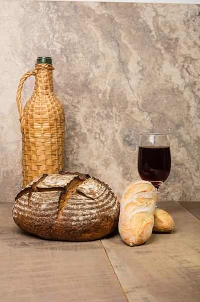 Loaf of fresh rye bread on a table - Fotó, kép