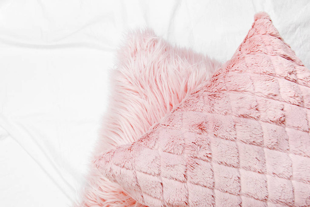 Bedding with a trendy pink pillows . Copy space. Flat lay, top view - Photo, Image
