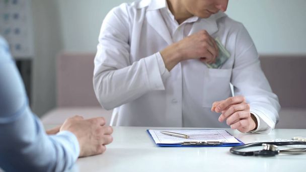 Doctor writing fake medical examination, taking bribe, expensive checkups - Fotó, kép