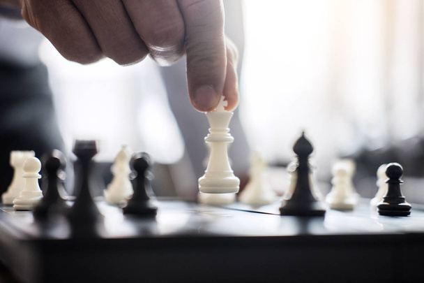 Hands of confident businessman colleagues playing chess game to development analysis new strategy plan, leader and teamwork concept for win and success. - Foto, Imagem