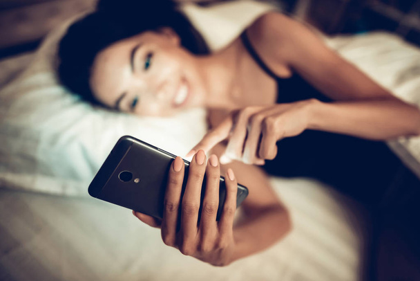 Girl Texting on Mobile Phone in Low Light. - Φωτογραφία, εικόνα