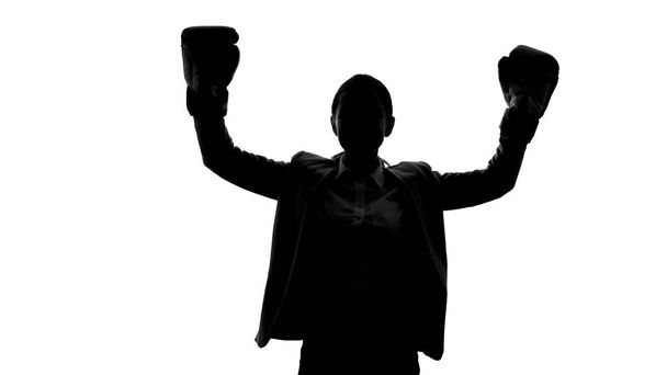 Strong woman in boxing gloves raising hands, success and equal rights concept - Фото, изображение