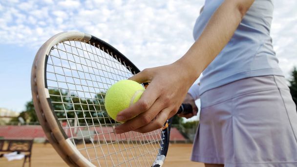Bottom view of beautiful woman serving tennis ball, professional sport, hobby - Foto, immagini
